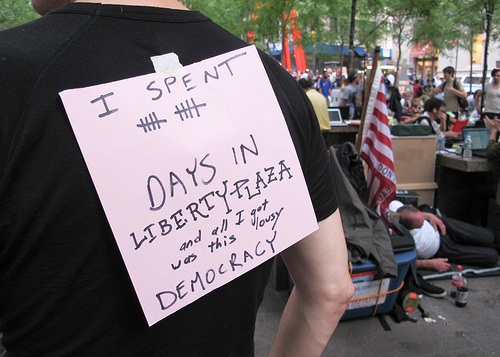 Protester with sign on back